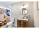 Bathroom features a decorative shower curtain, stylish vanity, round mirror and natural light fixture at 5121 Raintree Rd, Durham, NC 27712