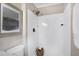 Bathroom featuring a walk-in shower with a rainfall shower head and built-in shelving at 5121 Raintree Rd, Durham, NC 27712