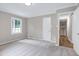 Bedroom with neutral walls, carpet flooring, a window with natural light and a doorway at 5121 Raintree Rd, Durham, NC 27712