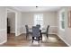 Cozy dining room with modern furniture and natural light from large windows at 5121 Raintree Rd, Durham, NC 27712