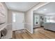 Inviting foyer featuring hardwood floors, a bench, and a seamless transition into the living room at 5121 Raintree Rd, Durham, NC 27712