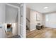 Spacious foyer with hardwood floors, a bench, staircase leading to the upper level and a view to the finished basement at 5121 Raintree Rd, Durham, NC 27712