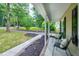 Inviting front porch with comfortable seating, offering a relaxing outdoor space and landscaping at 5121 Raintree Rd, Durham, NC 27712