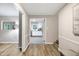 Bright hallway with hardwood floors and views into the kitchen and living room creating an inviting atmosphere at 5121 Raintree Rd, Durham, NC 27712