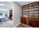 Open-concept living room features a brick fireplace, wooden shelves, and a seamless flow at 5121 Raintree Rd, Durham, NC 27712