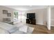 Relaxing living room with hardwood floors, neutral paint, and comfortable, modern furniture at 5121 Raintree Rd, Durham, NC 27712