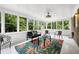 Bright sunroom surrounded by windows, providing a serene view of the outdoors at 5121 Raintree Rd, Durham, NC 27712