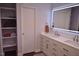 Stylish bathroom with a double sink vanity, illuminated mirror, and open shelving for organized storage at 515 Wildwood Dr, Durham, NC 27712