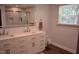 Bright bathroom featuring a double vanity with white countertops and a glass-enclosed tile shower at 515 Wildwood Dr, Durham, NC 27712