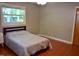 Bedroom with hardwood floors, neutral walls, and a window offering natural light at 515 Wildwood Dr, Durham, NC 27712