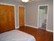 Bedroom featuring wood floors, a closet, and access to an adjacent bathroom at 515 Wildwood Dr, Durham, NC 27712