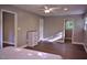 Spacious bedroom showcasing wood-look flooring, a ceiling fan, and neutral walls, enhancing a clean and modern design at 515 Wildwood Dr, Durham, NC 27712