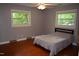 Bedroom with hardwood floors, large windows, and a bed, creating a peaceful retreat at 515 Wildwood Dr, Durham, NC 27712