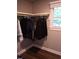 Well-organized closet with hanging clothes and window, providing ample storage space at 515 Wildwood Dr, Durham, NC 27712