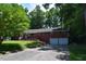 Charming brick home featuring a two-car garage, complemented by lush landscaping and a paved driveway at 515 Wildwood Dr, Durham, NC 27712