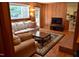 Cozy living room with wood paneling, fireplace, and adjacent kitchen view at 515 Wildwood Dr, Durham, NC 27712