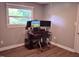 Dedicated office space with multiple monitors, desk, chair, and abundant natural light at 515 Wildwood Dr, Durham, NC 27712