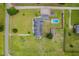 Aerial view of home surrounded by large grassy yard including pool, outbuilding and multi-car parking at 5200 Pulley Town Rd, Zebulon, NC 27597