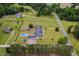 Expansive aerial view of a large country home with a pool, barn, and surrounding green pastures at 5200 Pulley Town Rd, Zebulon, NC 27597