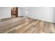 Open basement area featuring plank flooring and view of a bathroom at 5200 Pulley Town Rd, Zebulon, NC 27597