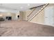 Finished basement featuring new carpeting, a staircase with wooden rails, and a spacious, versatile layout at 5200 Pulley Town Rd, Zebulon, NC 27597