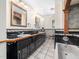 Bathroom with dual sinks, vanity, tile floor, and a separate bathtub with tile surround at 5200 Pulley Town Rd, Zebulon, NC 27597
