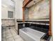 Bathroom with tile floor, bathtub with tile surround, and vintage-style fixtures at 5200 Pulley Town Rd, Zebulon, NC 27597