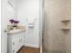 Cozy bathroom showcasing a vanity with tan countertops and a tiled walk-in shower with glass door at 5200 Pulley Town Rd, Zebulon, NC 27597