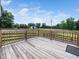 Inviting wooden deck with railing, showcasing scenic views and providing ample space for outdoor entertainment at 5200 Pulley Town Rd, Zebulon, NC 27597
