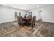 Charming dining area with a rustic wood table, neutral-toned chairs, and a stylish area rug at 5200 Pulley Town Rd, Zebulon, NC 27597