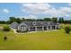 Stunning view of the gray exterior with covered porch, green yard and lush landscaping surrounding the home at 5200 Pulley Town Rd, Zebulon, NC 27597
