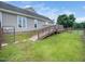 Well-kept exterior with a wooden ramp, offering accessible entry and a view of the fenced backyard at 5200 Pulley Town Rd, Zebulon, NC 27597