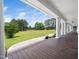Inviting front porch featuring white columns and a beautiful view of the expansive front lawn at 5200 Pulley Town Rd, Zebulon, NC 27597