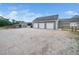 Detached three-car garage with ample parking space, providing storage and convenience on a gravel driveway at 5200 Pulley Town Rd, Zebulon, NC 27597
