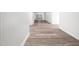 Bright hallway with plank flooring and white wainscoting leading to other rooms at 5200 Pulley Town Rd, Zebulon, NC 27597