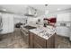 Expansive kitchen featuring a large island with a gas range, granite counters, and custom cabinets at 5200 Pulley Town Rd, Zebulon, NC 27597