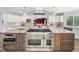 Gourmet kitchen features granite countertops, stainless steel appliances, and a modern vent hood at 5200 Pulley Town Rd, Zebulon, NC 27597