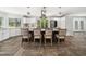 Spacious kitchen island with a granite countertop, barstool seating, stainless steel appliances, and ample natural light at 5200 Pulley Town Rd, Zebulon, NC 27597
