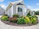 Beautiful landscaping surrounds the home's exterior with vibrant flowers and lush greenery at 5200 Pulley Town Rd, Zebulon, NC 27597