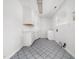 Spacious laundry room features tile flooring, ample cabinet space, and a utility sink at 5200 Pulley Town Rd, Zebulon, NC 27597