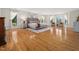 Spacious bedroom with hardwood floors, many windows with curtains, and a stylish rug at 5200 Pulley Town Rd, Zebulon, NC 27597