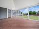 Spacious screened porch with wood flooring and a view of the backyard and pool at 5200 Pulley Town Rd, Zebulon, NC 27597
