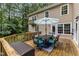 Back deck with table, six cushioned chairs and patio umbrella at 5805 Bayberry Ln, Raleigh, NC 27612