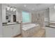 Bright bathroom with a soaking tub, walk-in shower, and granite countertops at 5805 Bayberry Ln, Raleigh, NC 27612