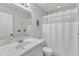Bright bathroom with white marble countertop vanity, shower and toilet at 5805 Bayberry Ln, Raleigh, NC 27612