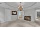 Neutral bedroom featuring a decorative mirror, chandelier and a door to the main bathroom at 5805 Bayberry Ln, Raleigh, NC 27612