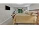 Relaxing bedroom with large window, TV, and decorative ceiling fan at 5805 Bayberry Ln, Raleigh, NC 27612