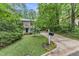Quaint two-story house with well-maintained lawn, complemented by mature trees and a long driveway at 5805 Bayberry Ln, Raleigh, NC 27612
