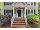 Inviting front entrance with brick steps, white railings, black door, and well-maintained landscaping at 5805 Bayberry Ln, Raleigh, NC 27612