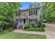 Charming two-story home with wood siding, black shutters, manicured lawn, and an American flag at 5805 Bayberry Ln, Raleigh, NC 27612